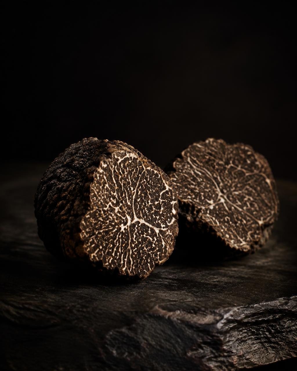 Fresh black winter truffle from Teruel cut in half, showing its marbled interior